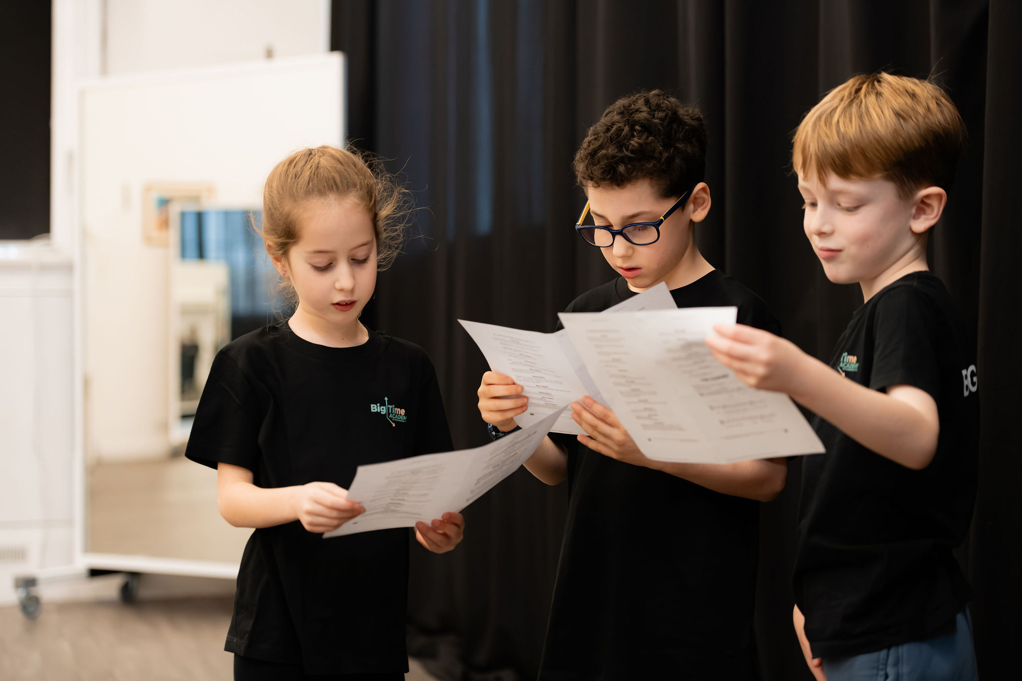 Big Time students reading from song sheets